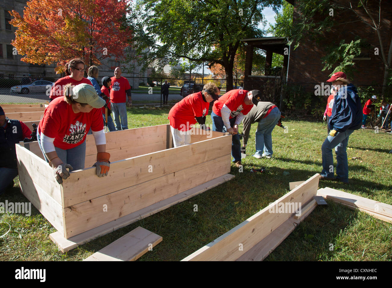 Detroit, Michigan - Volunteers from the United Methodist Church build planting boxes for a community garden. Stock Photo