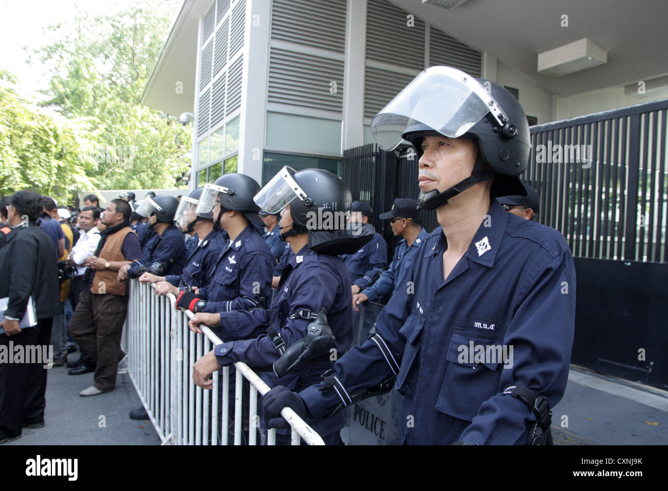 Riot policemen standing guard during a protest Stock Photo - Alamy
