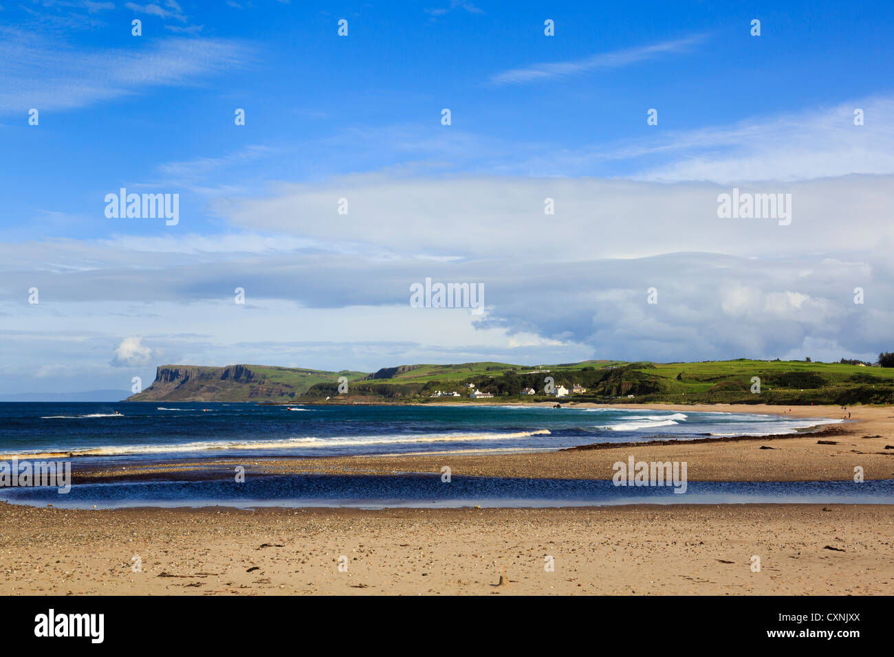 View across bay and sandy beach to Fair Head or Benmore headland on northeast coast. Ballycastle County Antrim Northern Ireland UK Stock Photo
