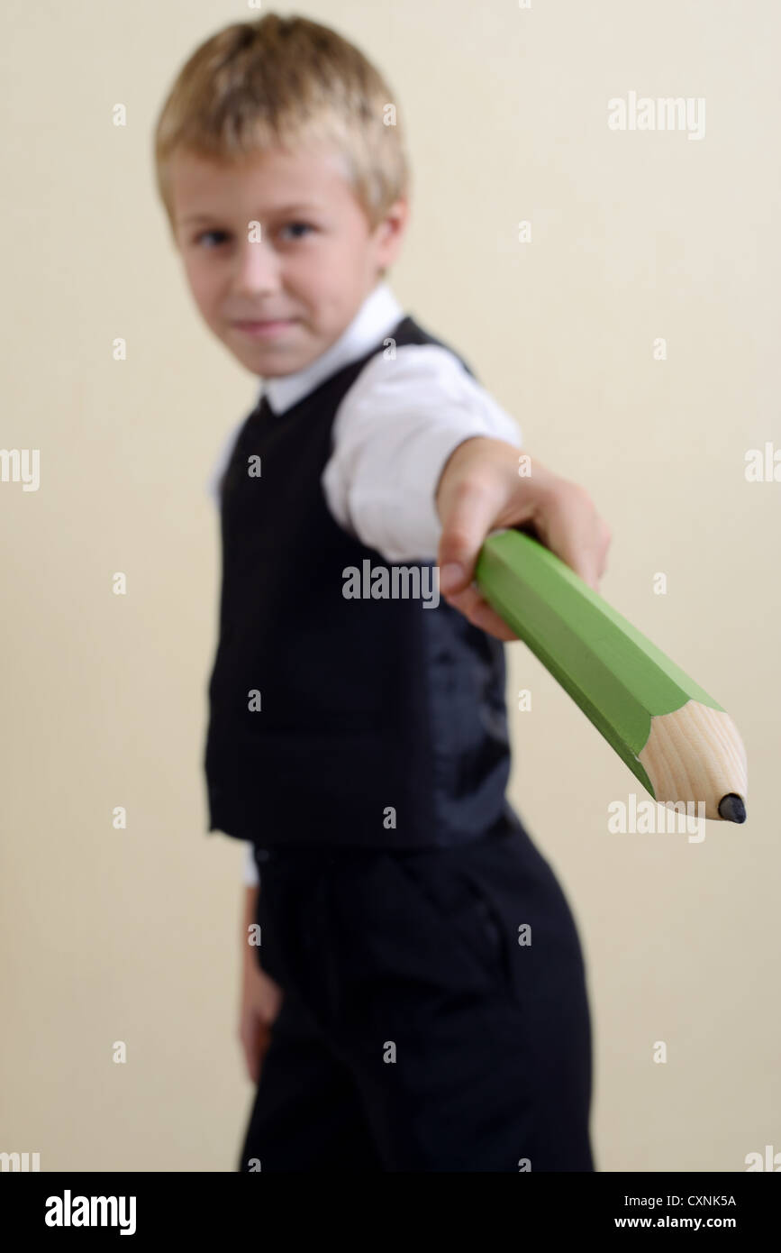 brave schoolboy with big pencil Stock Photo