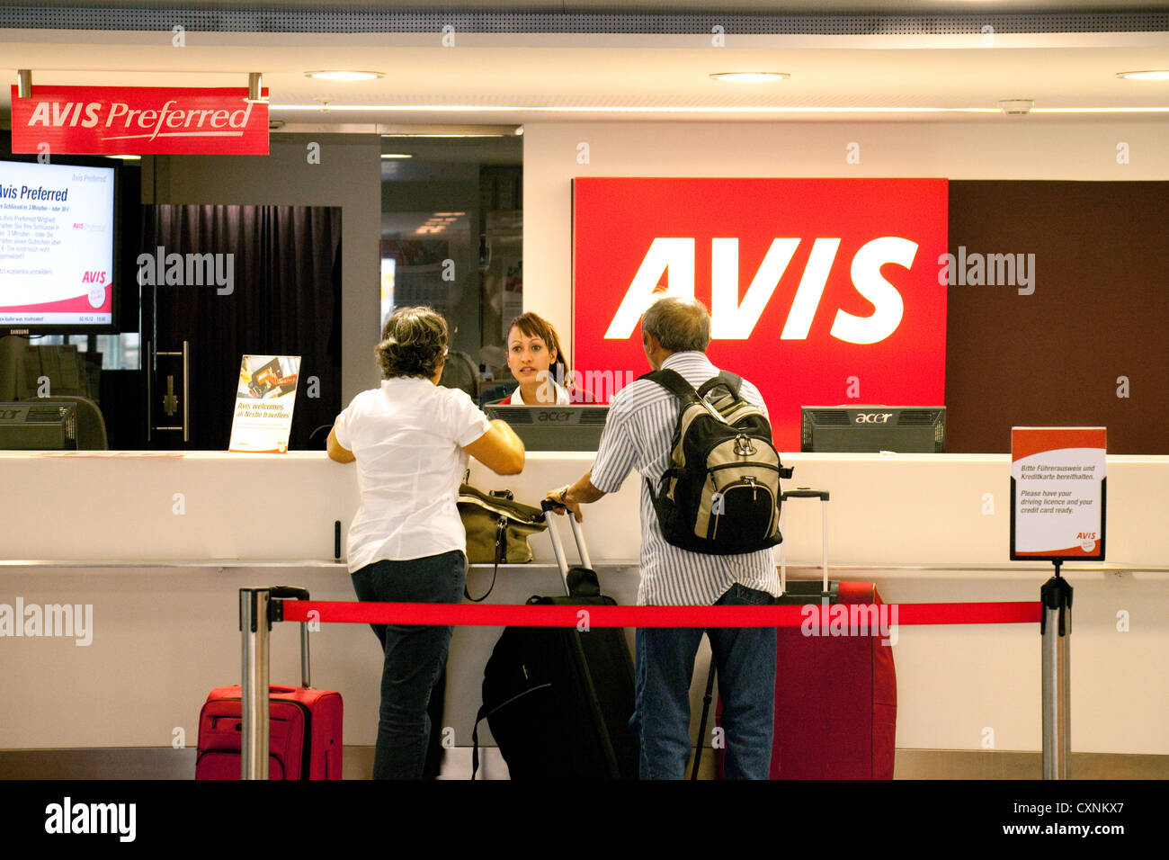People hiring a car, Avis car rental desk, Zurich airport, Switzerland Europe Stock Photo