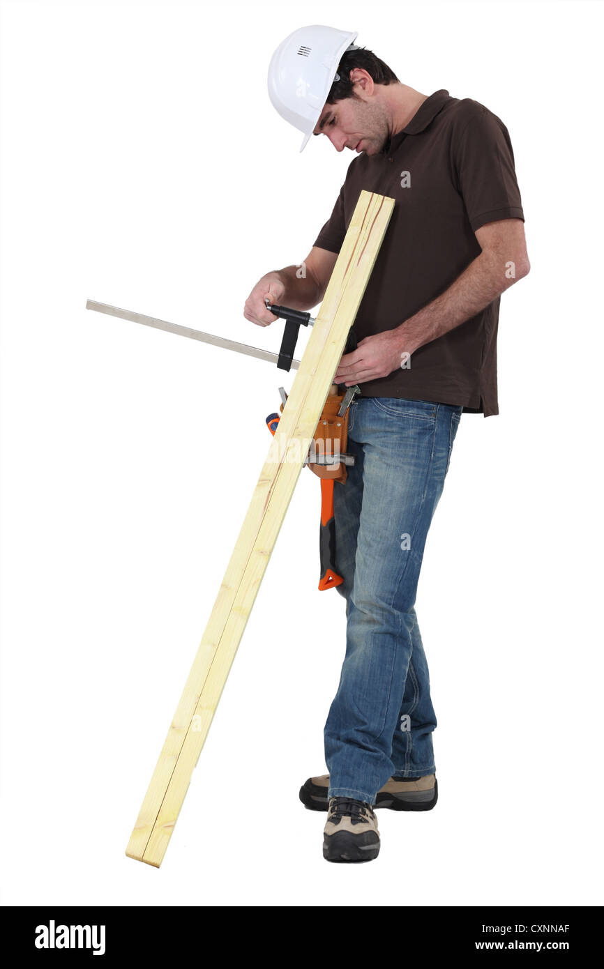 Tradesman gluing two wooden planks together Stock Photo
