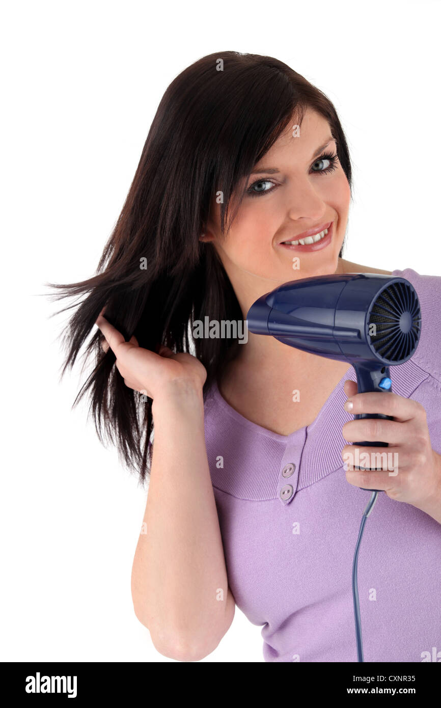 Woman using a hairdryer Stock Photo Alamy