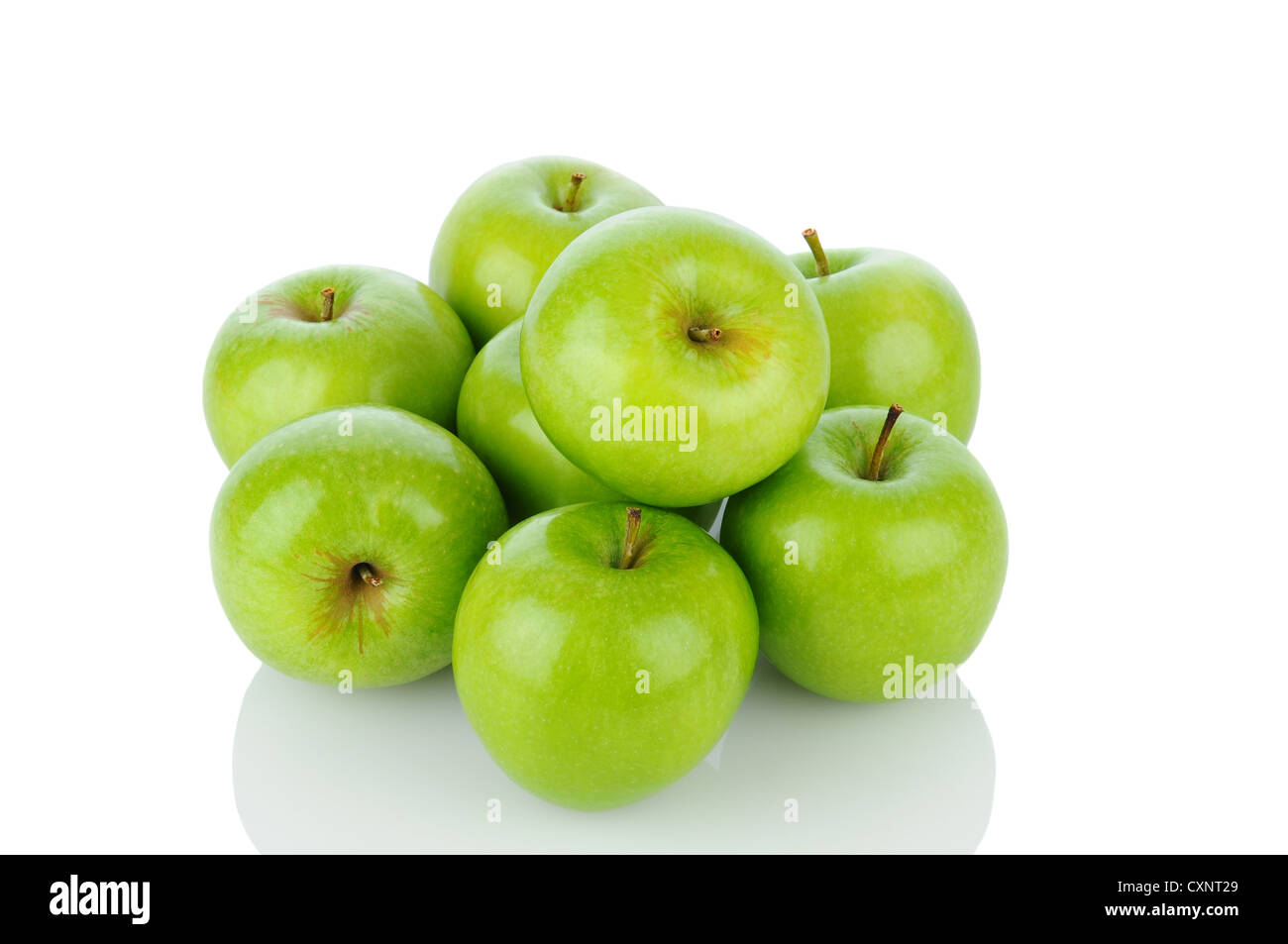A pile of Granny Smith apples on white with reflection. Horizontal format. Stock Photo