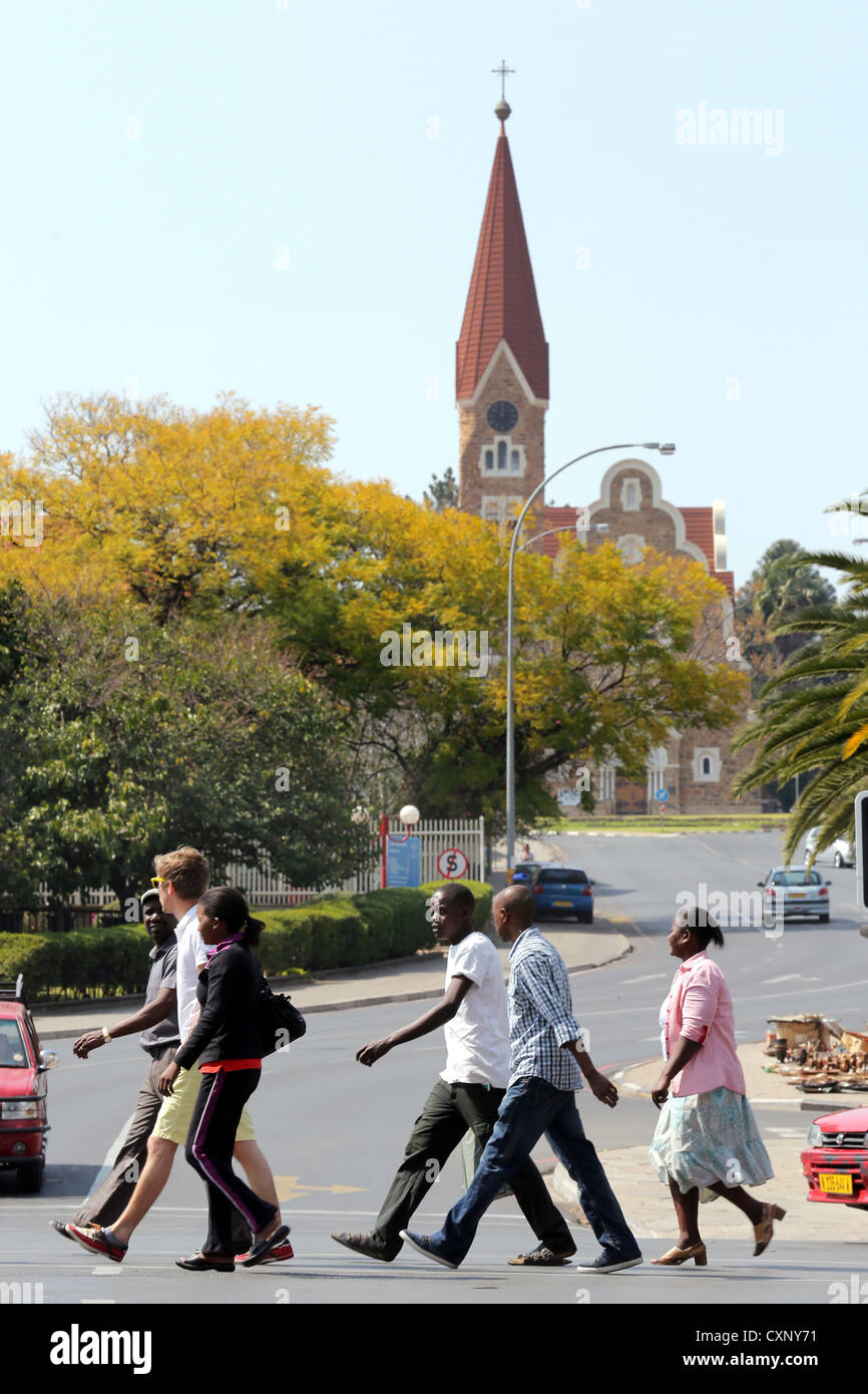 people crossing street underneath Christ Church (Christuskirche) in Windhoek, Namibia Stock Photo
