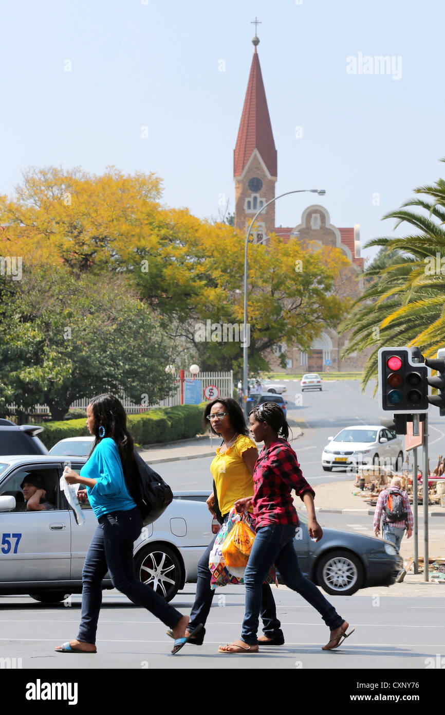 people crossing street underneath Christ Church (Christuskirche) in Windhoek, Namibia Stock Photo