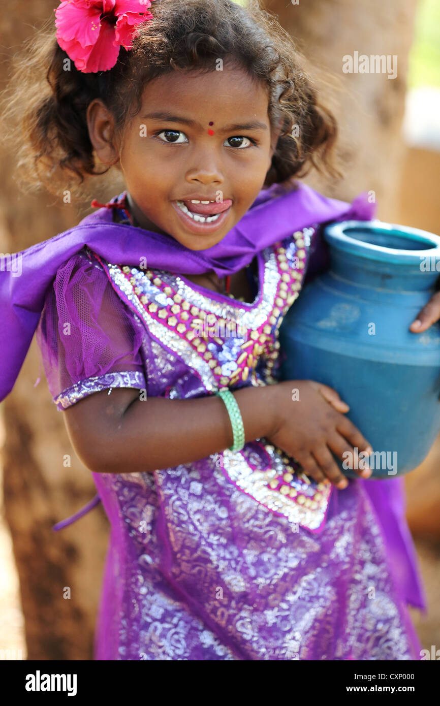 Young Indian girl carrying a little water pot Andhra Pradesh South India Stock Photo