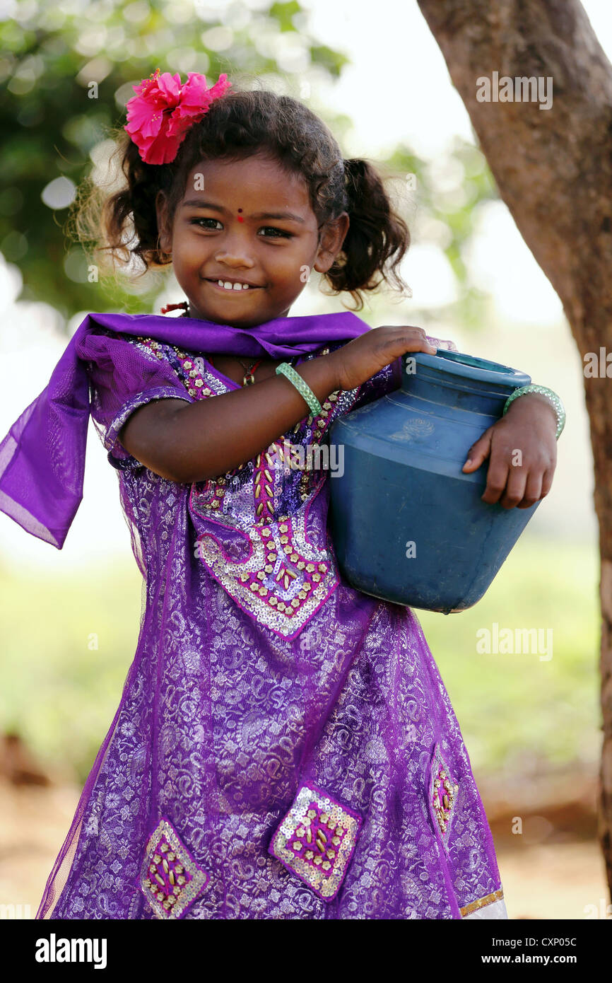 Young Indian girl carrying a little water pot Andhra Pradesh South