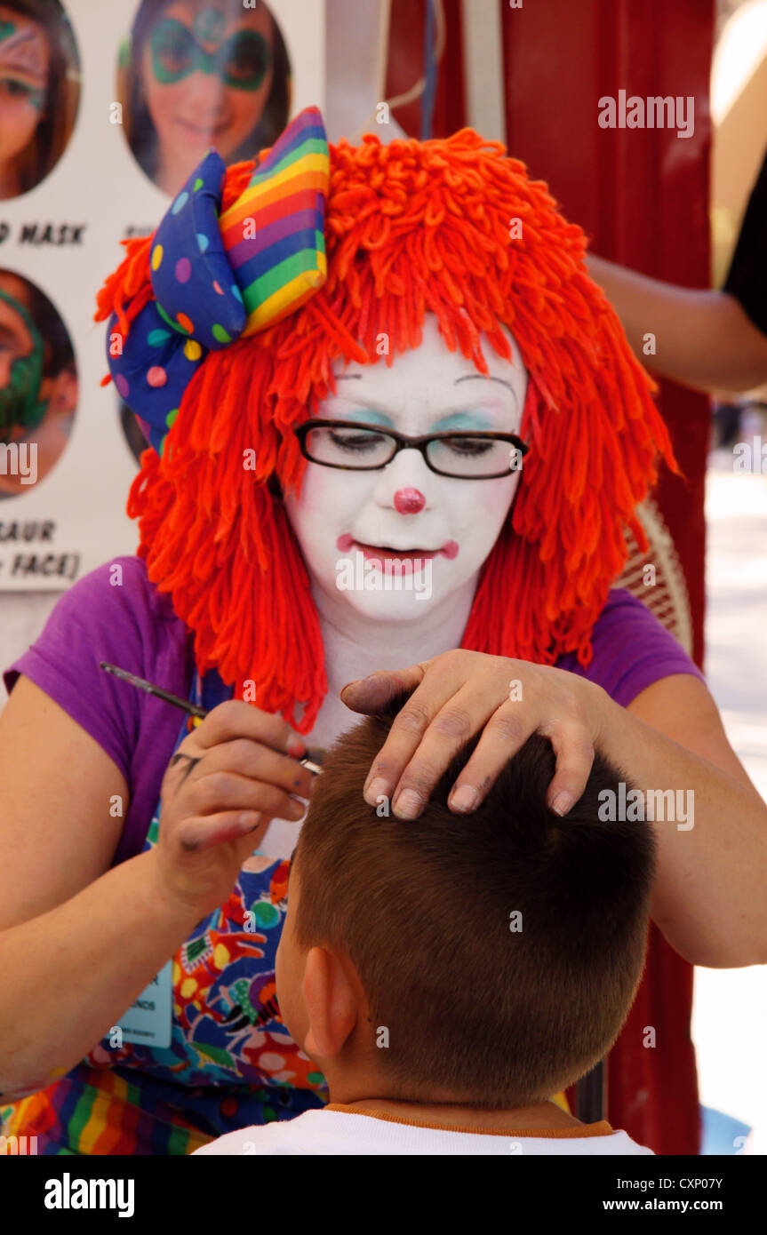 woman female clown doing face painting new mexico state fair midway