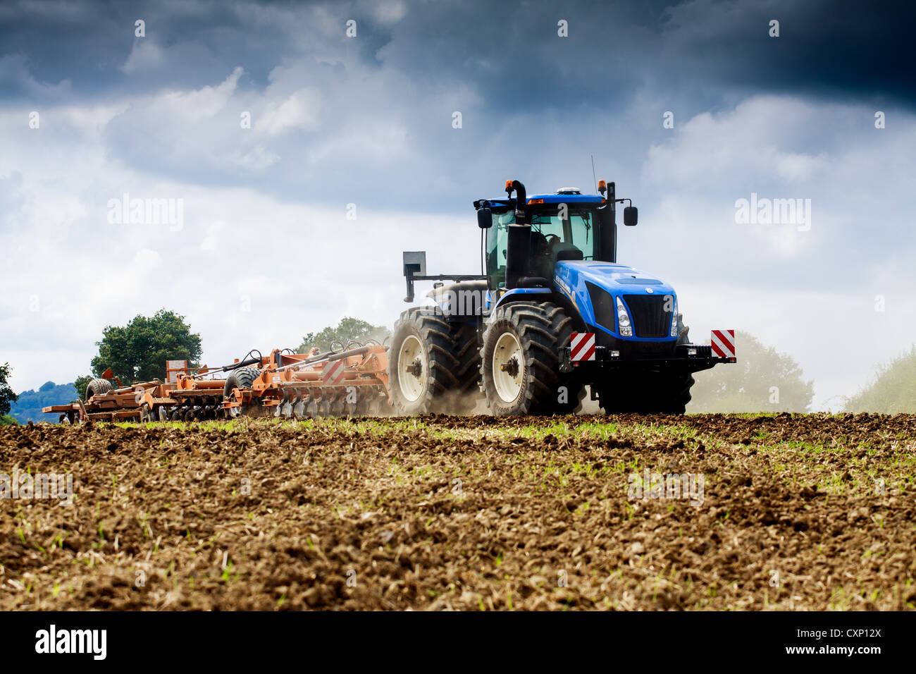 Cultivating the soil using a New Holland T9.560 tractor and a Simba sld460 Stock Photo