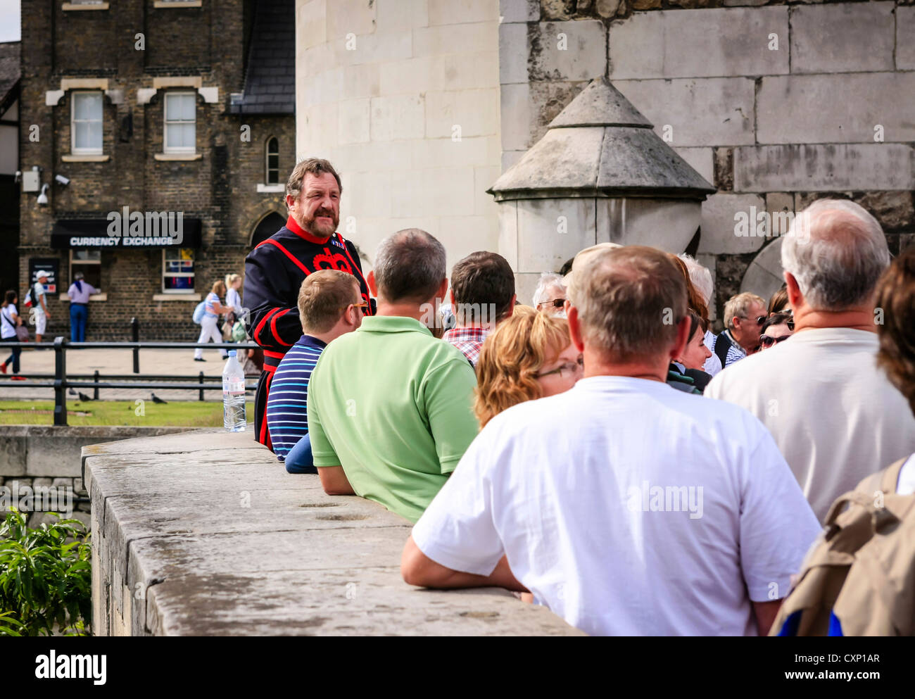 Beefeaters give a guided walk n talk around the Tower of London complex Stock Photo