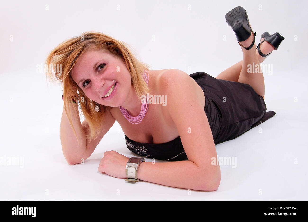 Blonde woman in black ankle length strapless dress Stock Photo