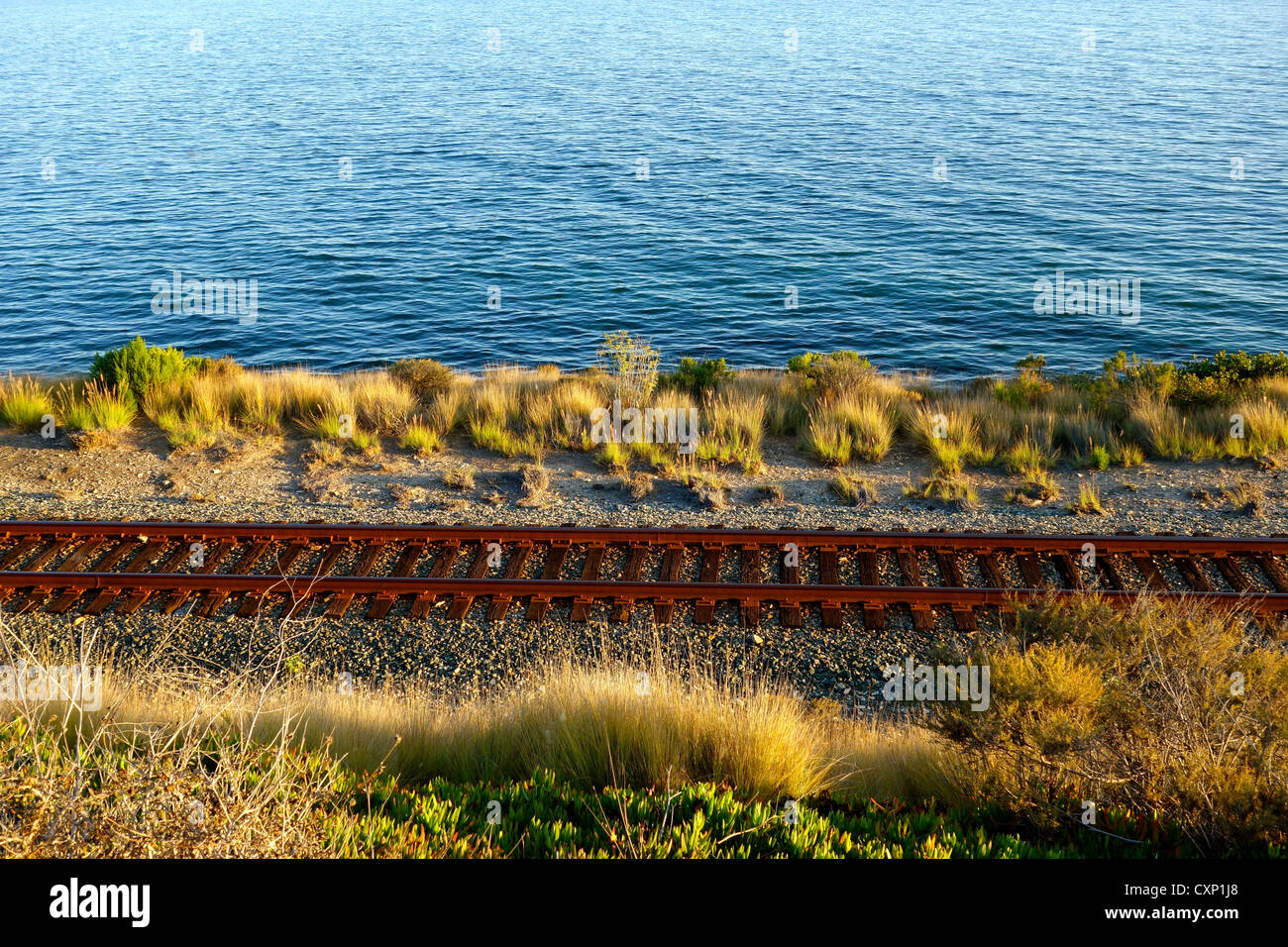 Train tracks along the ocean in California used by Amtrak's Pacific Surfliner and Coast Starlight trains. Stock Photo