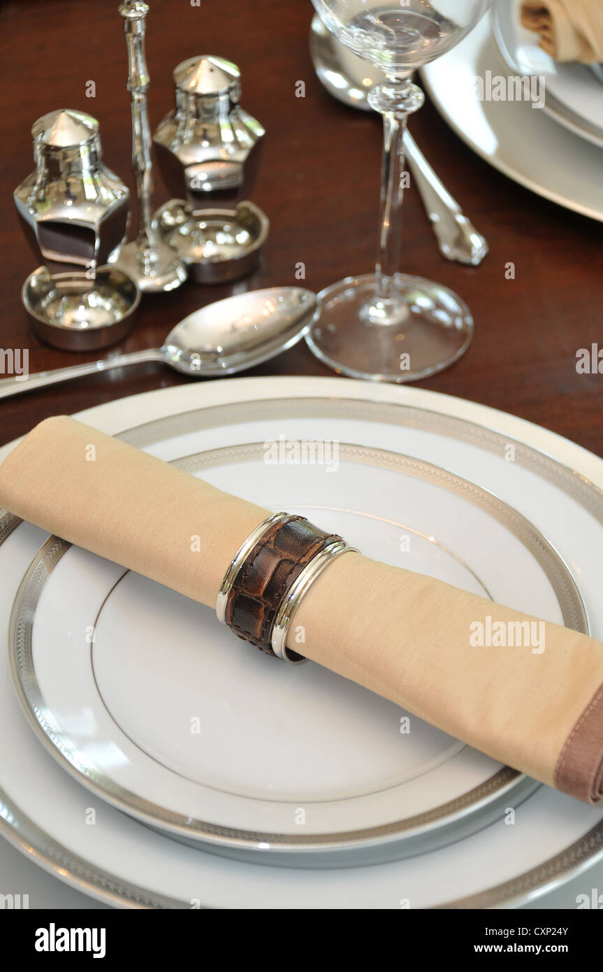 A table place setting including napkin plates and cutlery Stock Photo