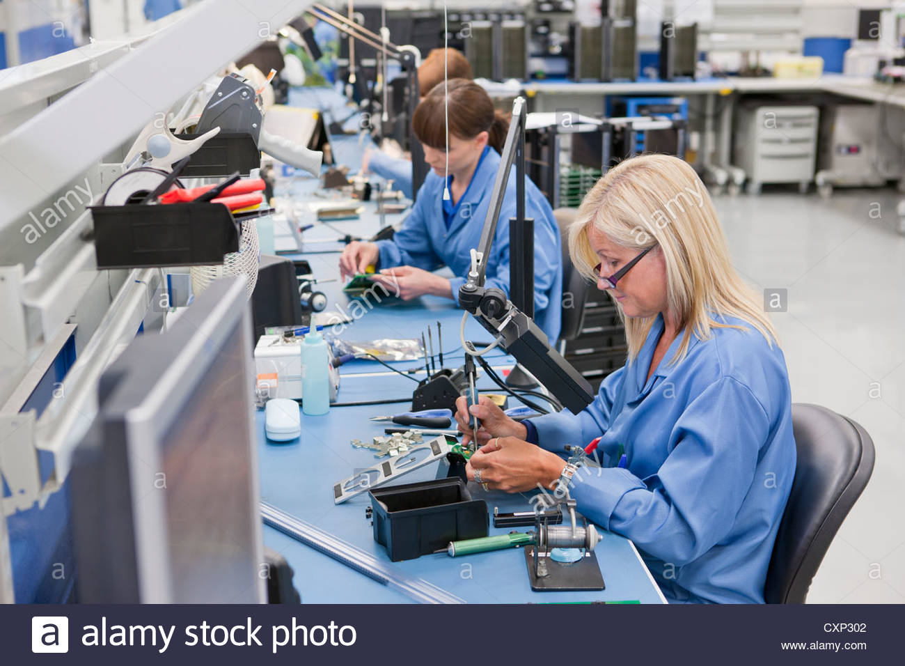 technicians working on assembly line in hi tech electronics manufacturing CXP302