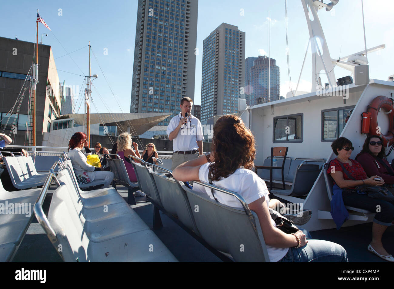 Tour Guide On A Boston Harbor Cruise Boat Taking Tourists On A Forty Five Minute Tour Of Boston Harbor Stock Photo