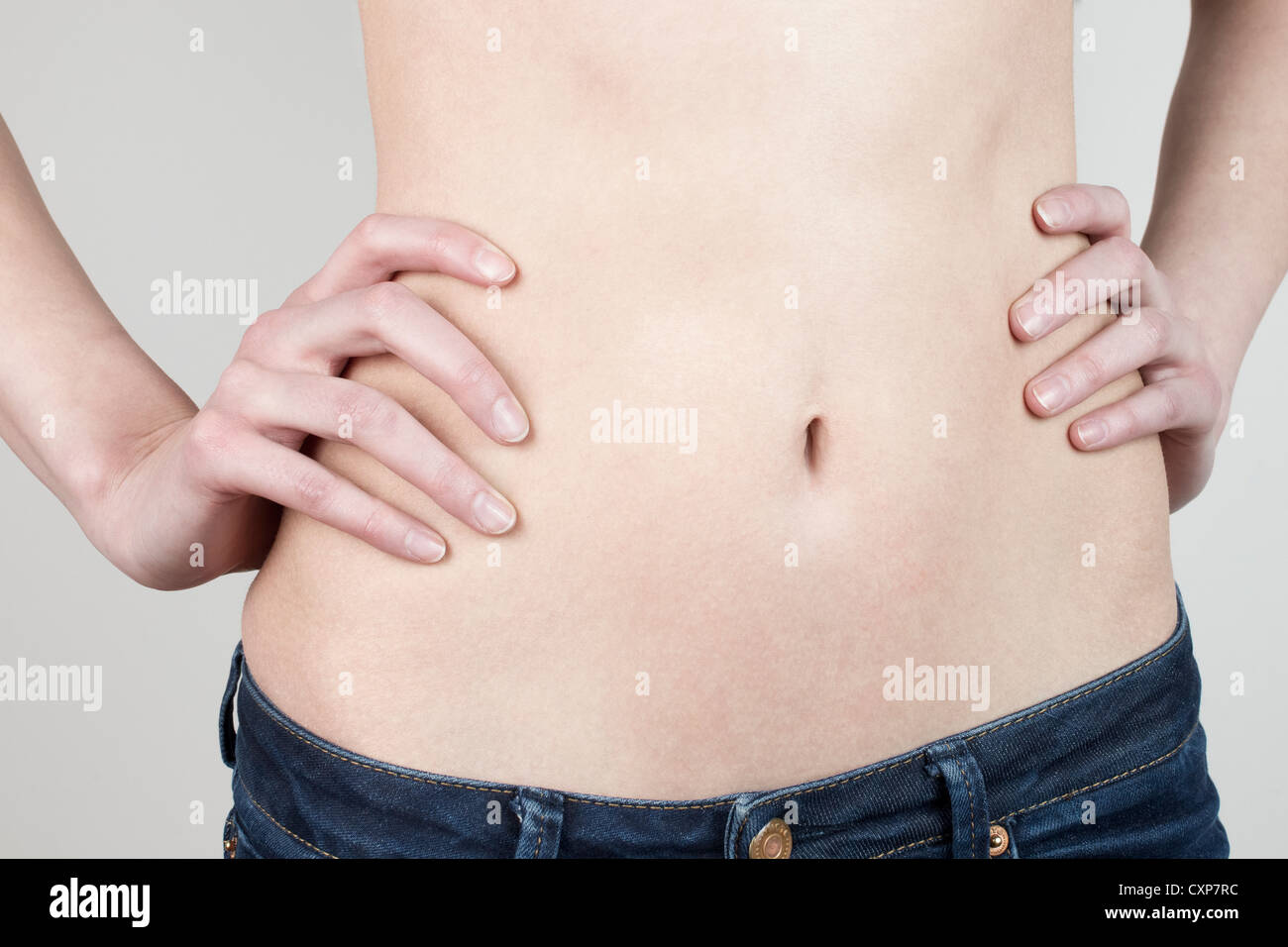 Woman's flat, thin stomach Stock Photo