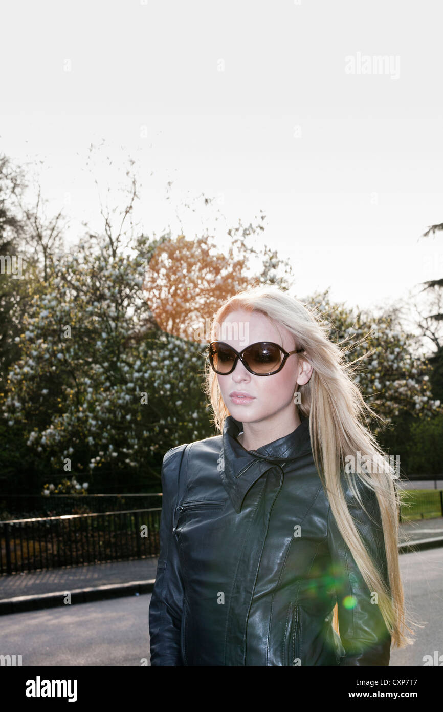 Woman with long blonde hair walking outdoors Stock Photo