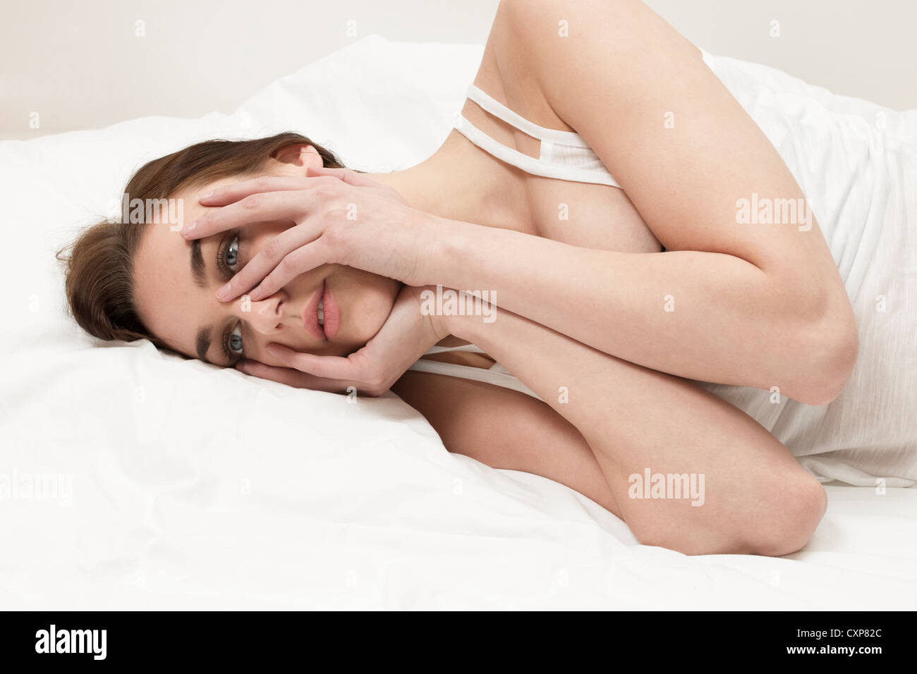 Insomnia, nightmare - woman awake in bed thinking because she can't sleep Stock Photo
