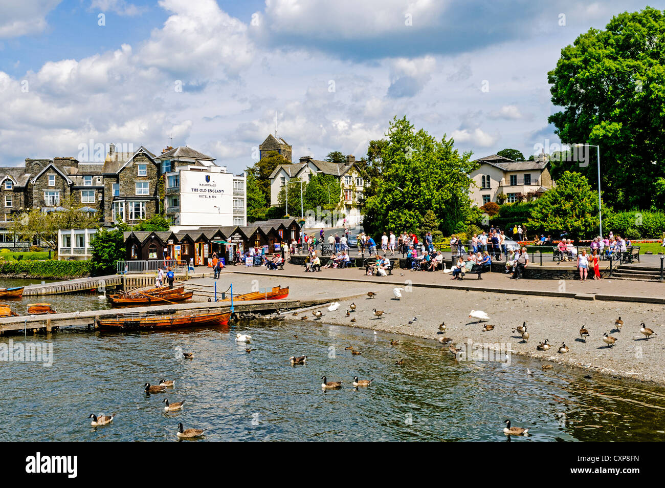 The busy promenade and quayside at Bowness overlooking rowing boats for