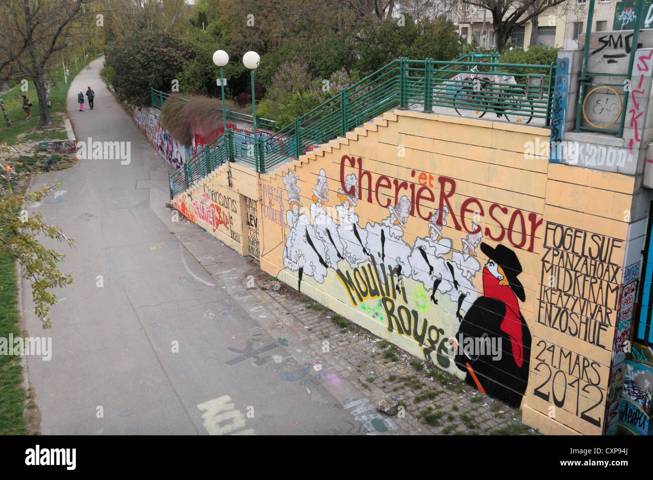 Artful graffiti (of the Moulin Rouge) near the Augarten bridge (Augartenbrücke), over the Danube Canal, Vienna, Austria. Stock Photo