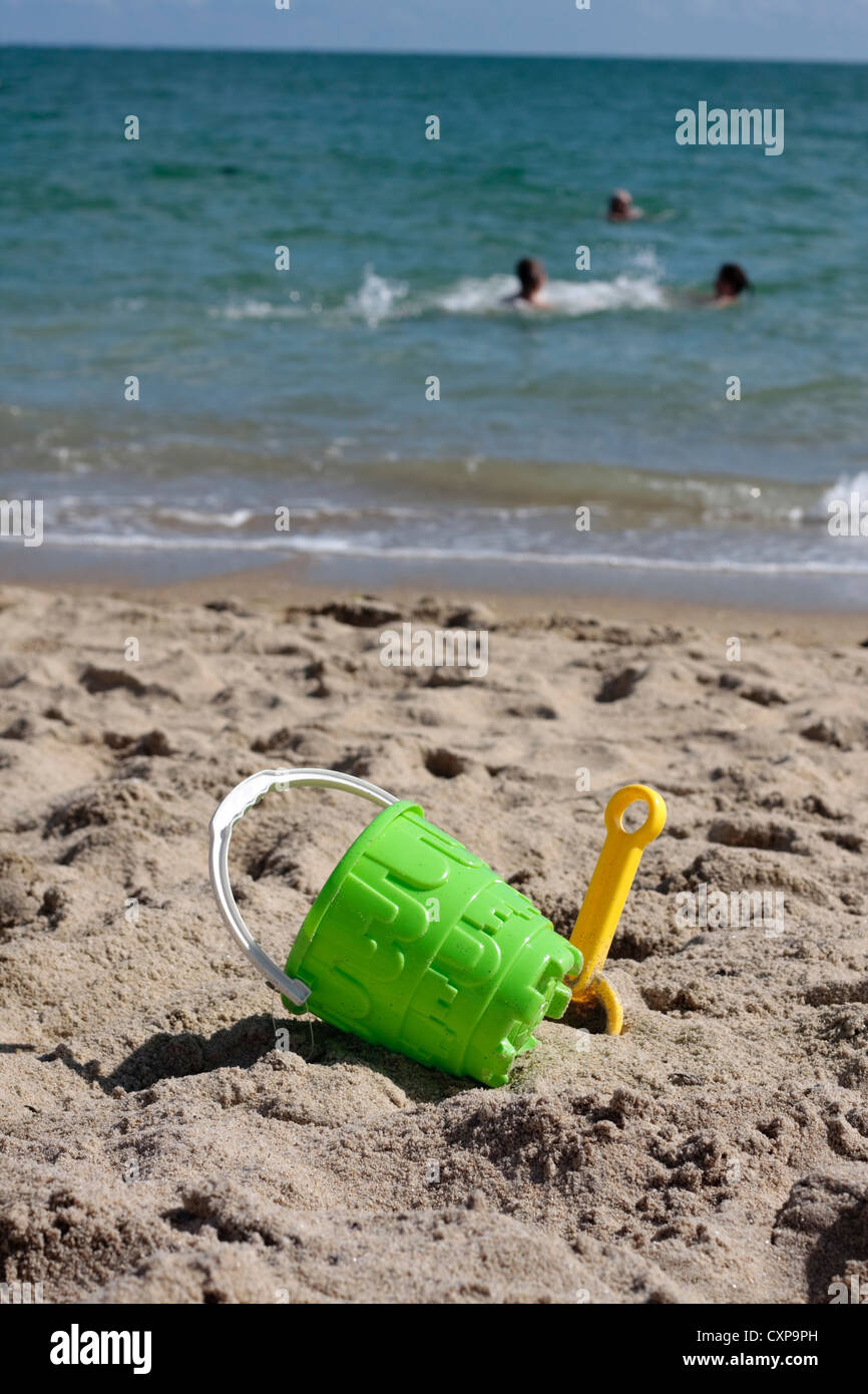 Bucket and spade on beach Stock Photo