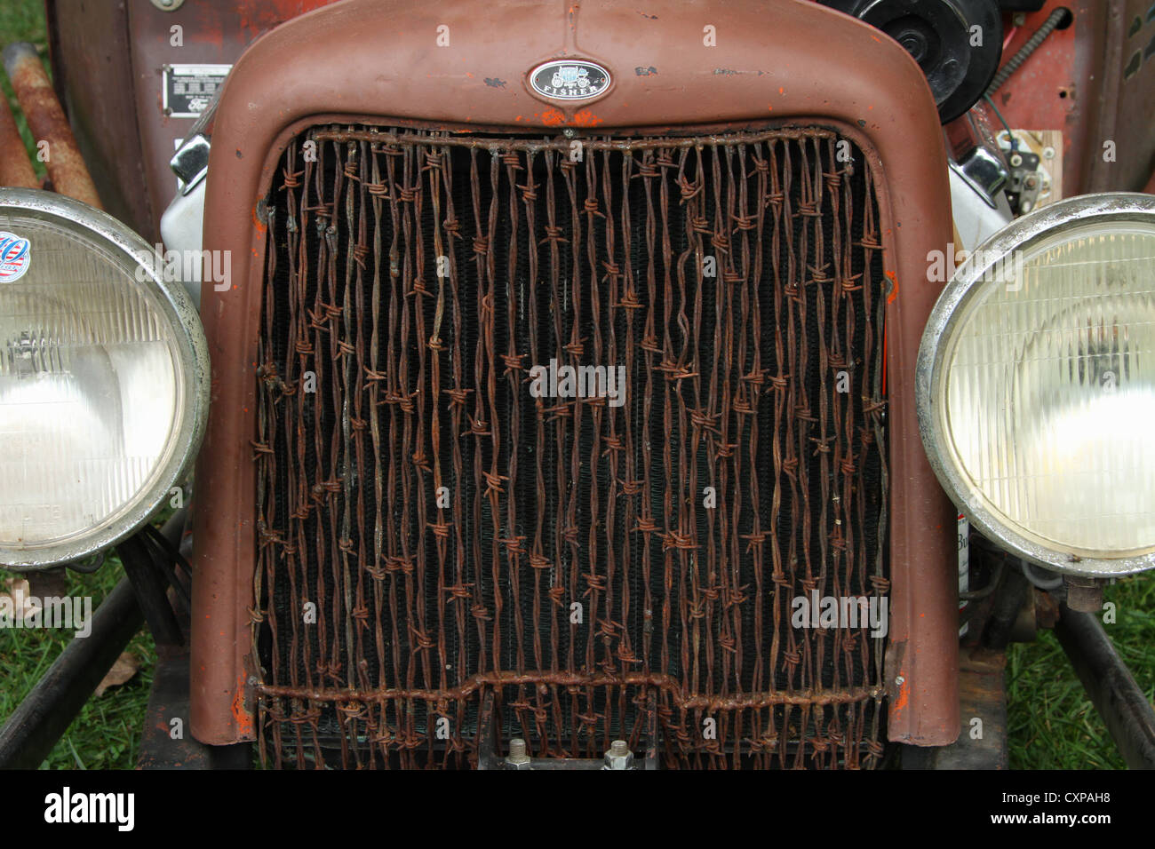Rat Rod radiator with barbed wire grill. Emblem at the top says Body By Fisher. Stock Photo