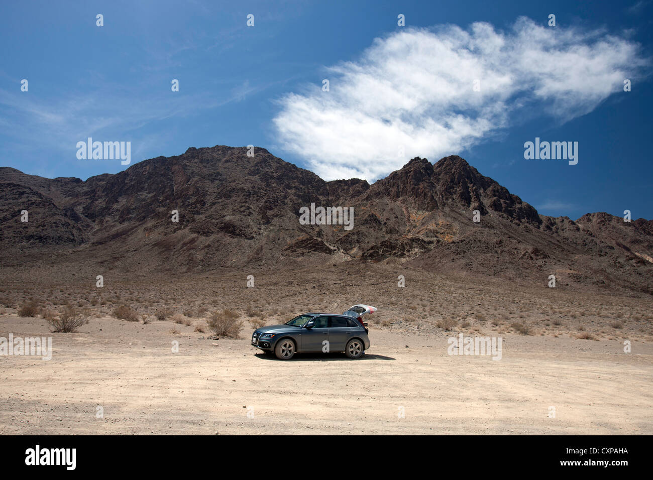 2012 grey Audi Q5 SUV with tailgate open in rocky hills Death Valley National Park California United States America Stock Photo