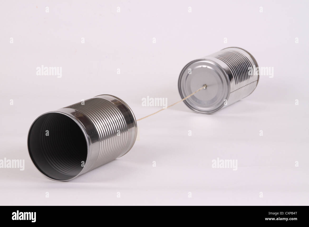 Two tin cans connected by a string Stock Photo Alamy