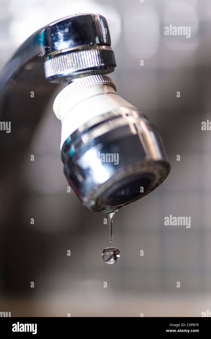 Old tap dripping water drops Stock Photo
