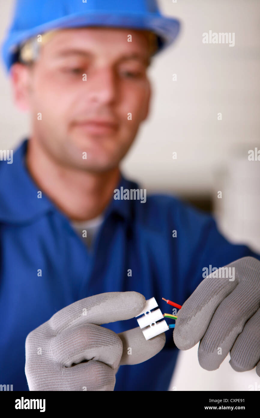 Electrician wiring a threeway connector strip Stock Photo Alamy