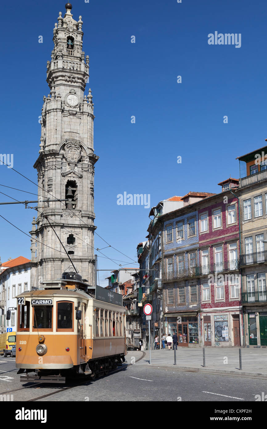 A traditional tram passes the Torre dos Clerigos tower in the historical centre of Porto (Oporto), Portugal Stock Photo