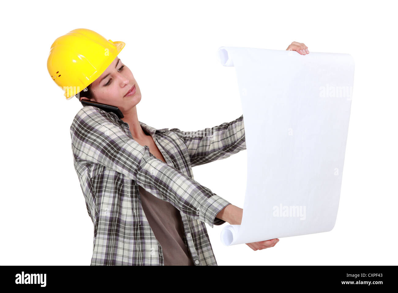 craftswoman looking at a blueprint Stock Photo - Alamy