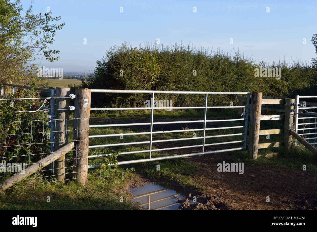 Farm gate steel field entrance countryside Stock Photo