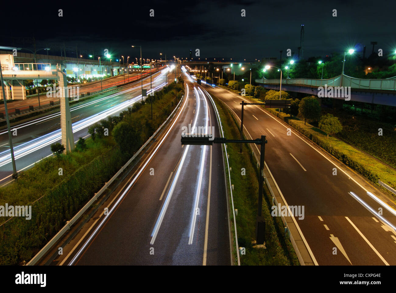 straight night highway with car's traces Stock Photo