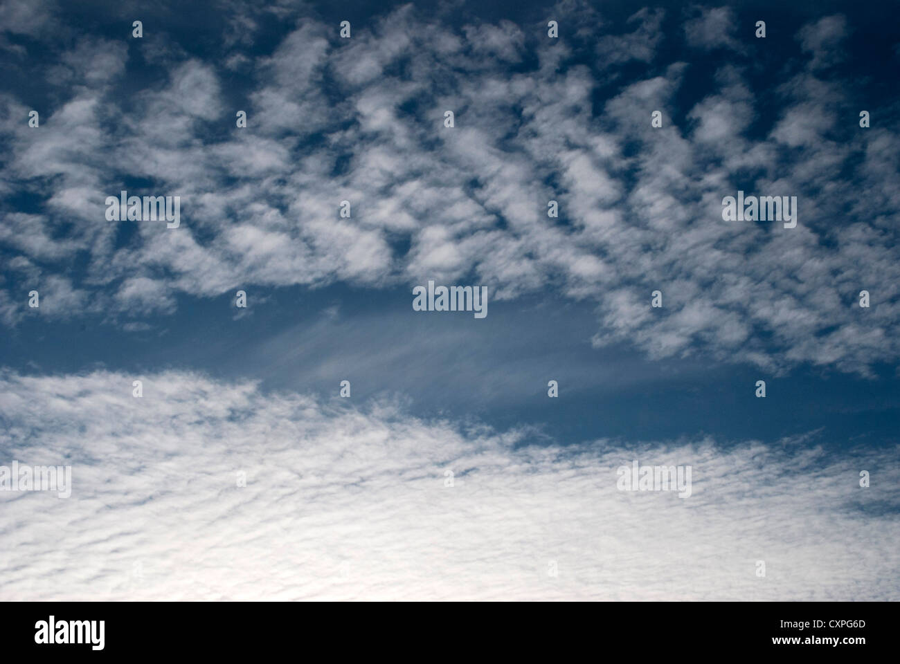 Deep blue sky with scattered mackerel sky altocumulus clouds Stock