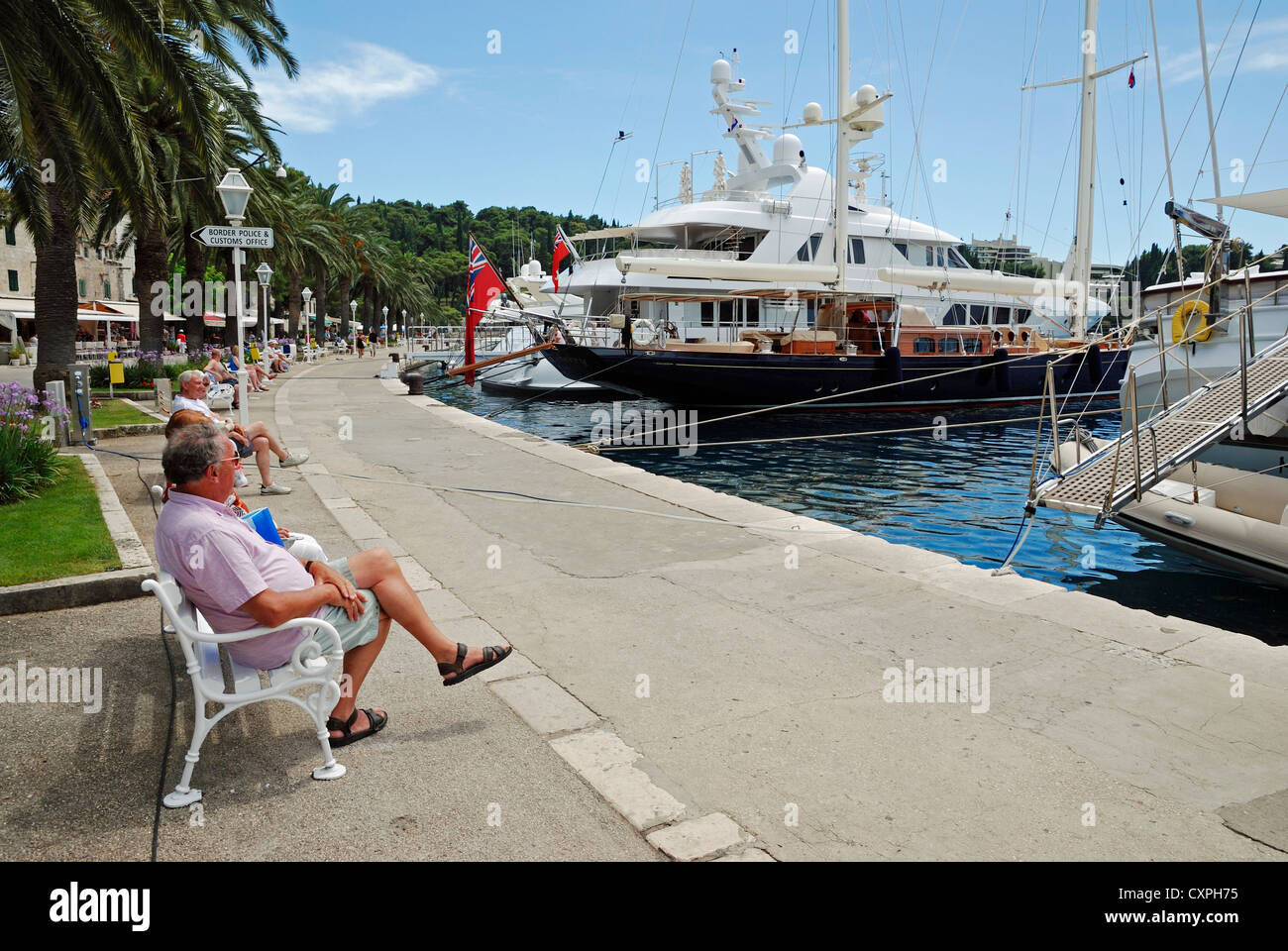 Holidaymakers relaxing on the waterfront at Cavtat, Croatia. Stock Photo