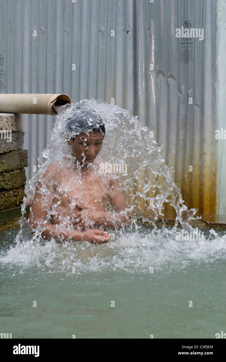 A Man takes a bath in a hot spring near Manali, North India Stock Photo