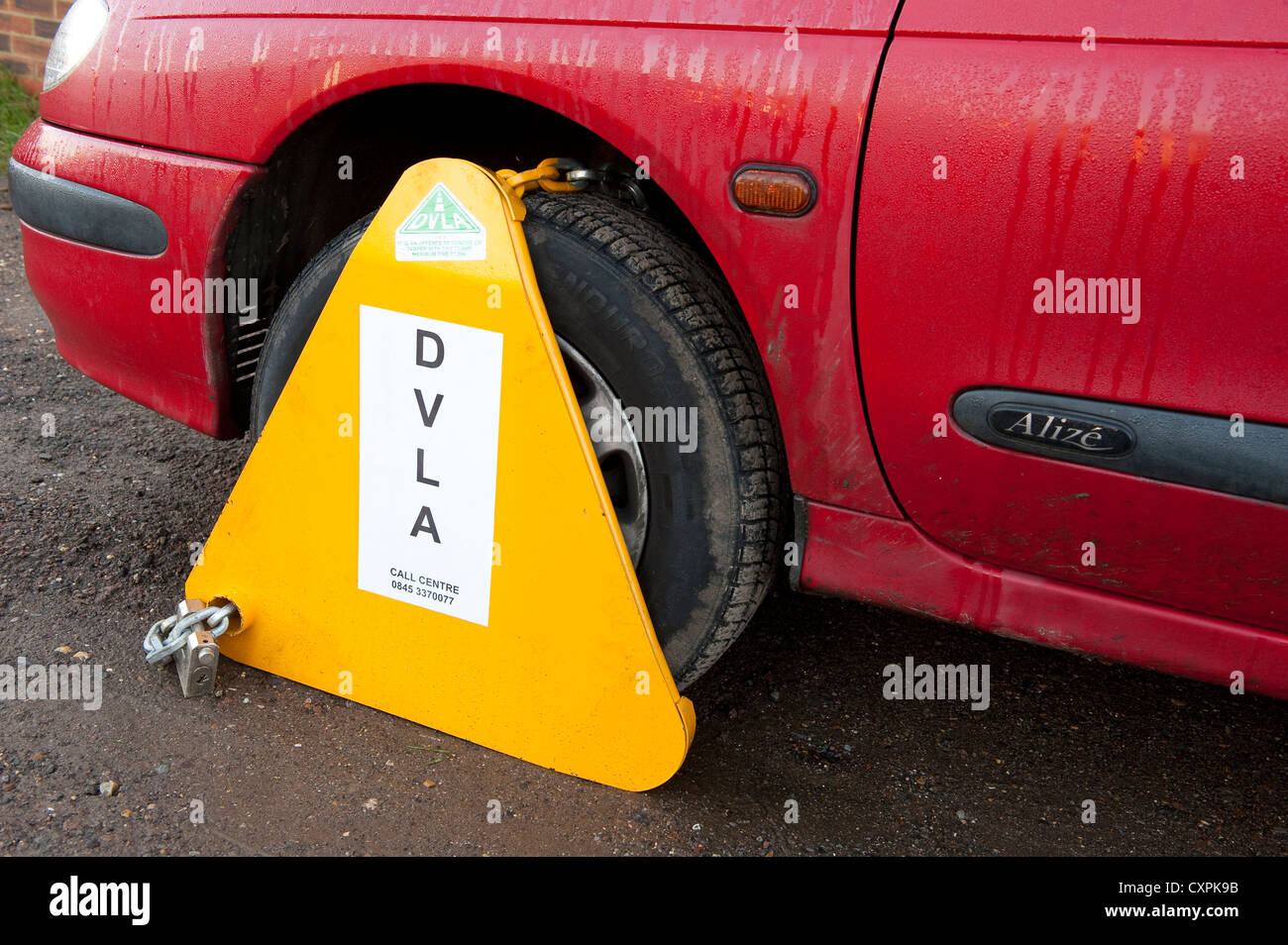 DVLA wheel clamp on a untaxed car parked on a street in England Stock Photo Alamy