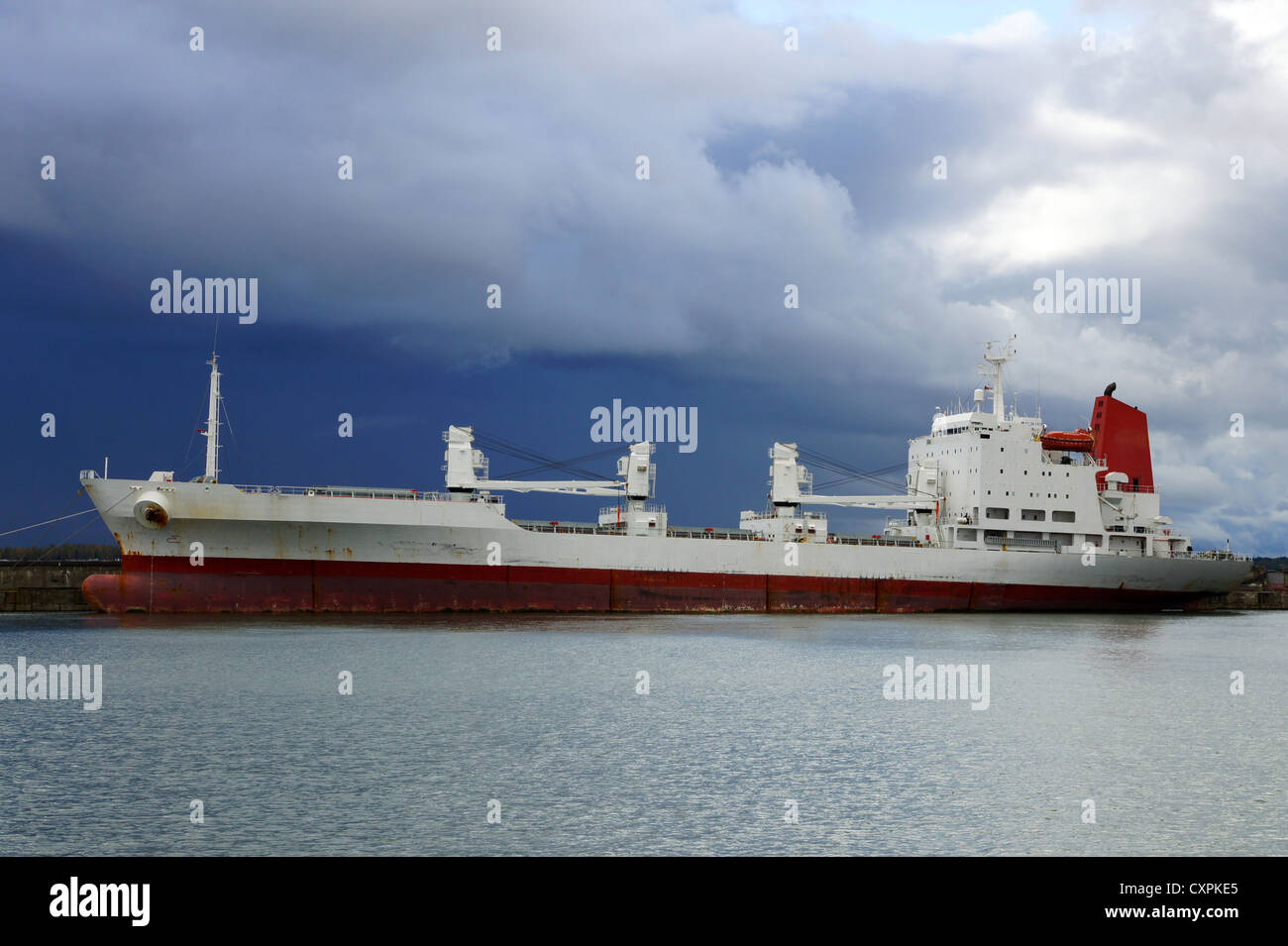 The cargo ship costs at a mooring Stock Photo