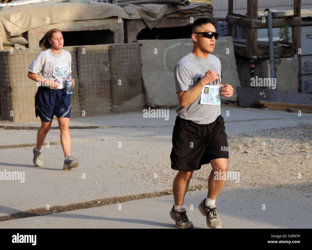 U.S. Army Spc. James Yi, a legal clerk working for NATO Training Mission-Afghanistan, who originally deployed from the 13th Expeditionary Sustainment Command from Fort Hood, Texas, participates in the Army Ten-Miler shadow run at Camp Eggers, Kabul, Afghanistan, Oct. 7. The run started at 6 a.m. to ensure low traffic on the run routes. Eggers is such a small place that runners had to do 16 laps on the designated track to cover ten miles. Stock Photo