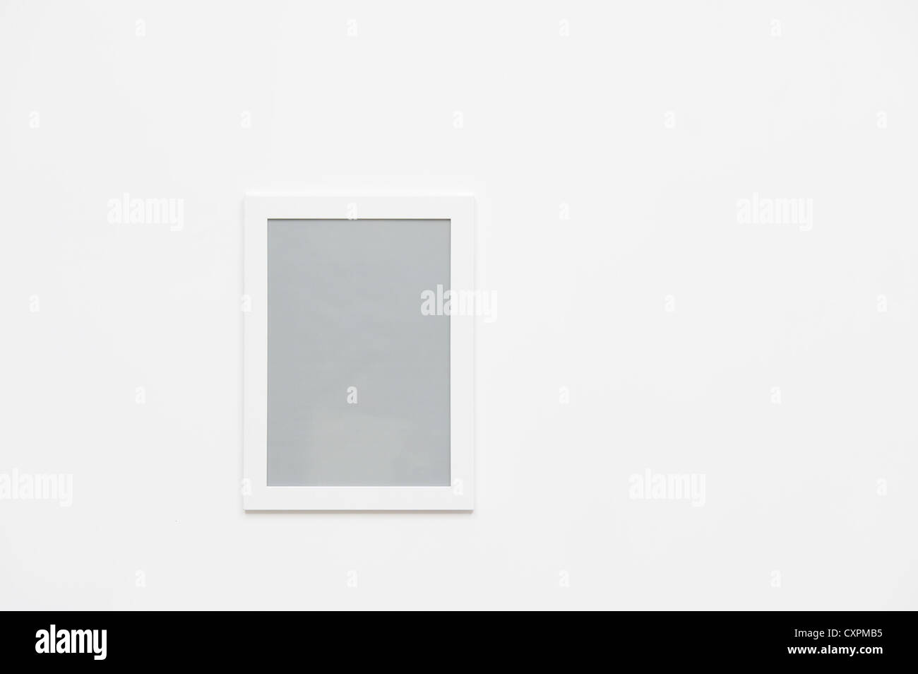 Photo frame hanging on the white wall Stock Photo