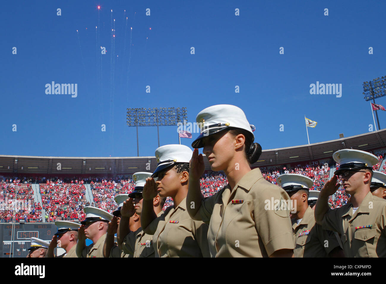 Lance Cpl. Leeana Richey, a motor transport operator serving with the 13th Marine Expeditionary Unit for San Francisco Fleet Week 2012, salutes during the singing of the national anthem at the 49ers game, Oct. 7, 2012. The U.S. Marines, sailors, coast guardsmen and members of the Royal Canadian Navy received a standing ovation as they left the field. Richey is a native of Indian Town, Fla., and is stationed at Marine Corps Base Camp Pendleton, Calif. Stock Photo