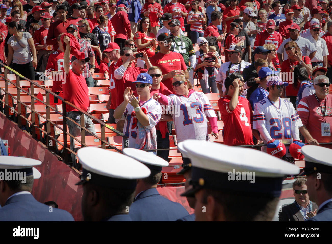 Football fans at the San Francisco 49ers vs. Buffalo Bills game at Candlestick Park give a standing ovation to U.S. Marines, sailors, coast guardsmen and members of the Royal Canadian Navy as they leave the field after the pregame show, Oct. 7, 2012. The service members with San Francisco Fleet Week 2012 marched on to the field to salute during the singing of the national anthem. Stock Photo