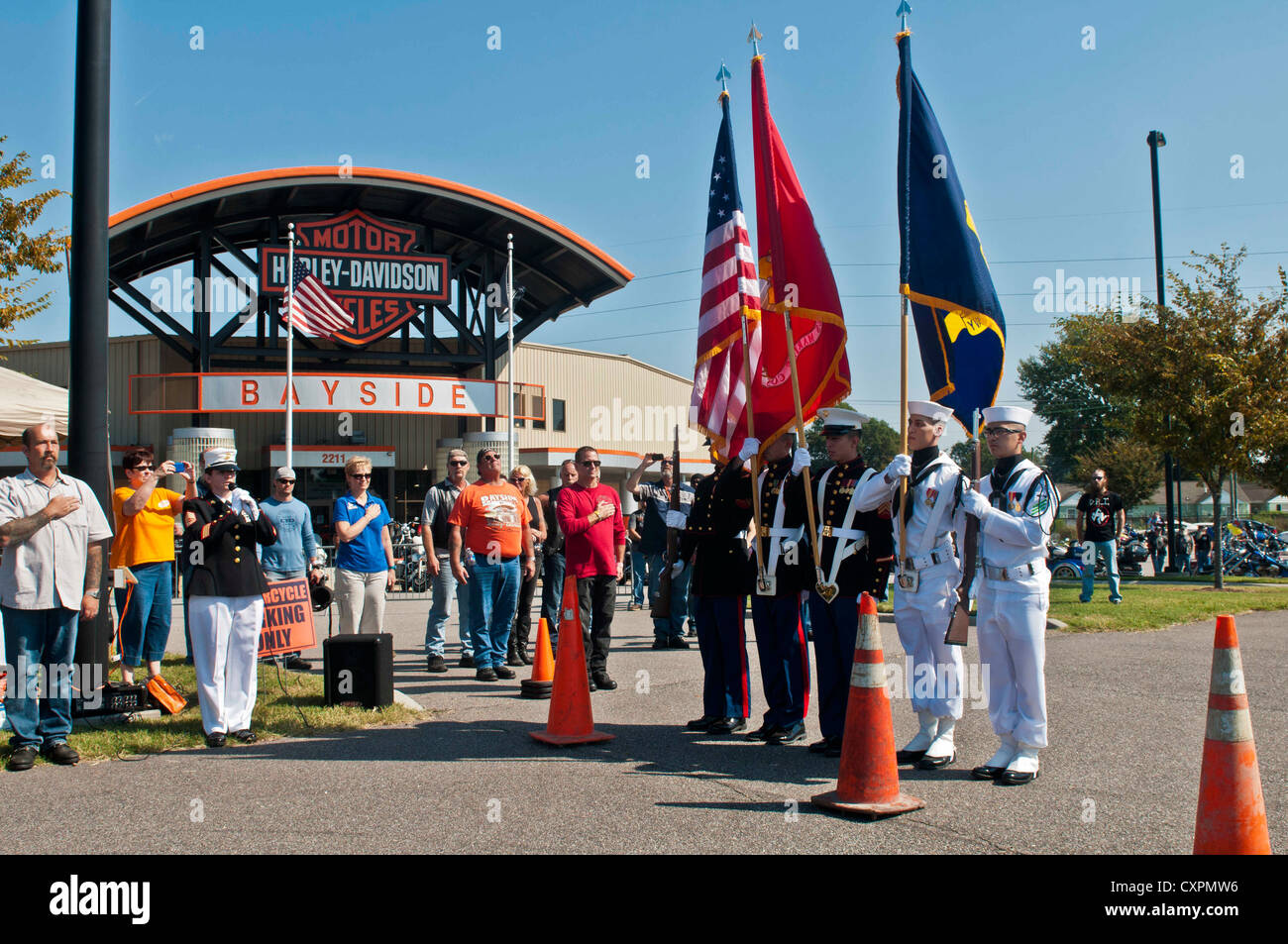 Sailors and Marines from Joint Expeditionary Base Little Creek-Fort Story, right, present colors while Marine Corps Gunnery Sgt. Angela Mink, left before the 12th Annual Fleet Ride at the Bayside Harley-Davidson in Portsmouth, Va. All proceeds from the event go to the Navy Marine Corps Relief Society. Stock Photo