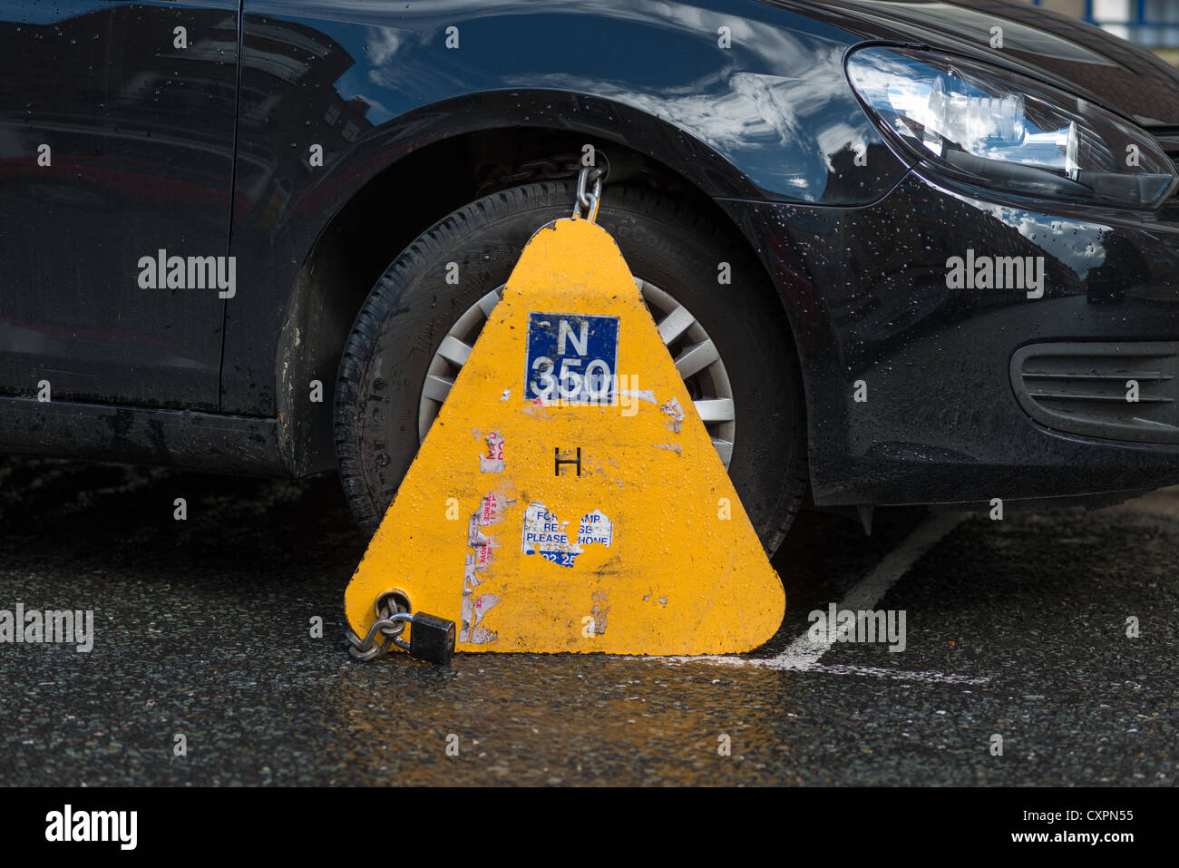 Car clamped with wheelclamp in Dublin city centre, Republic of Ireland. Stock Photo