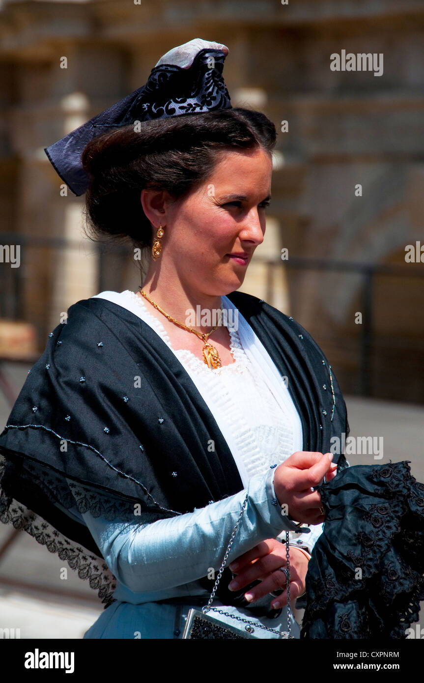 Arlesian woman dressed in traditional costume at the Fete des Gardians festival in the Roman city of Arles, Provence, France Stock Photo