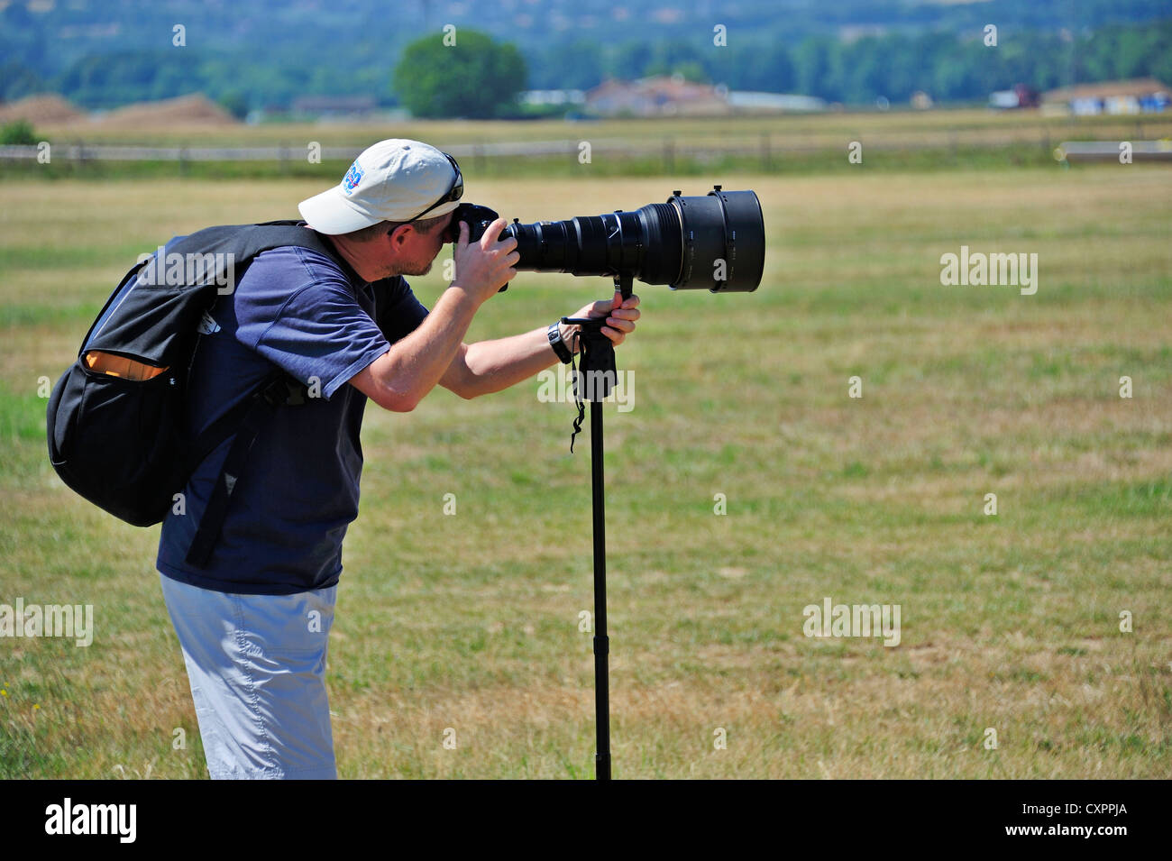 Photographer with a long telephoto lens Stock Photo