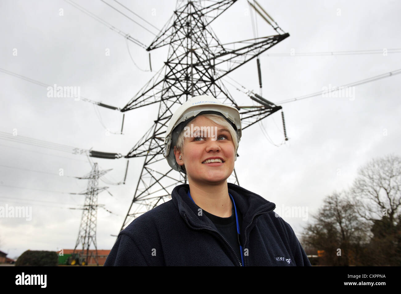 Portrait of young female apprentice working for  the National Grid, training to be an overhead cable technician Stock Photo