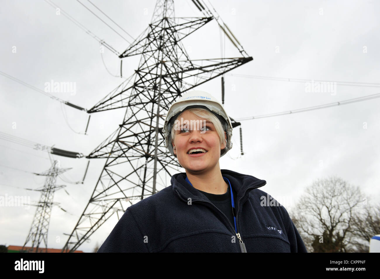 Portrait of young female apprentice working for  the National Grid, training to be an overhead cable technician Stock Photo